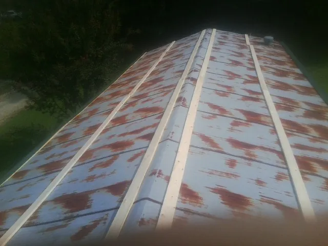 Rusted metal roof panels with new wood purlins before replacement — Storm Damage Roof Repair in Martinez by Roofing Brothers