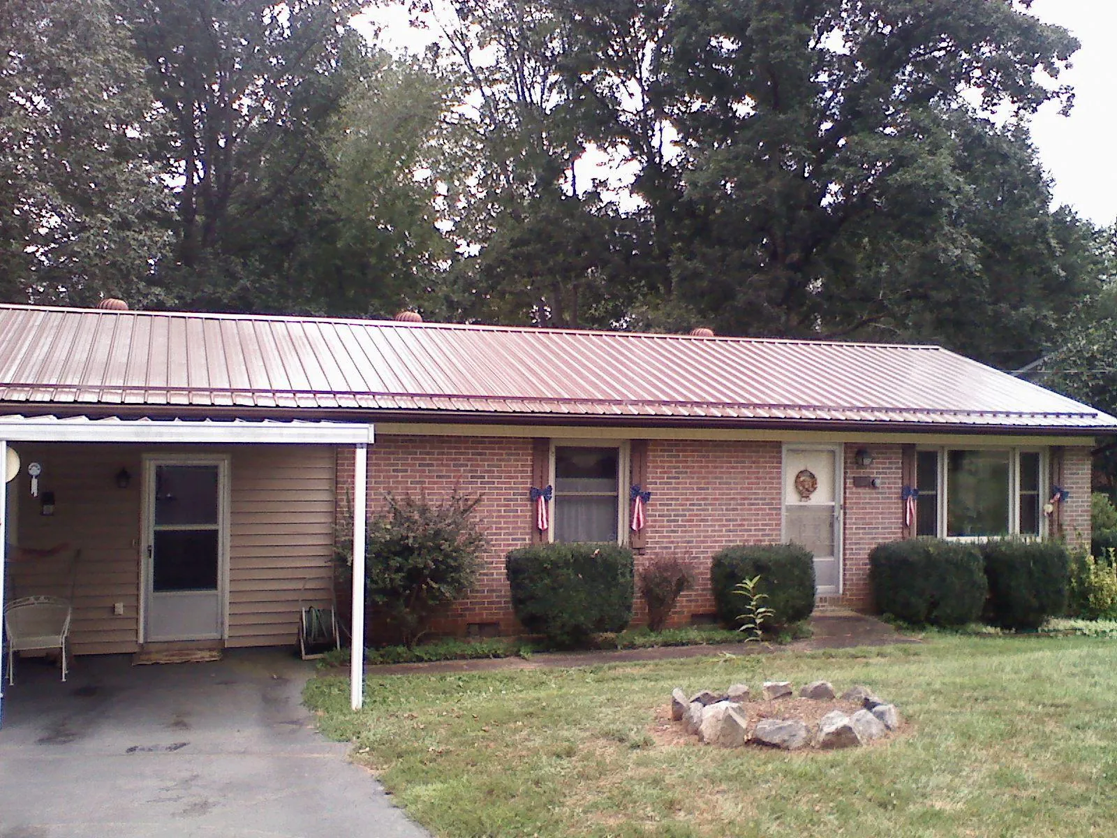 Bronze metal roof and carport on a brick ranch home — Roof Repair work by our crew in Martinez